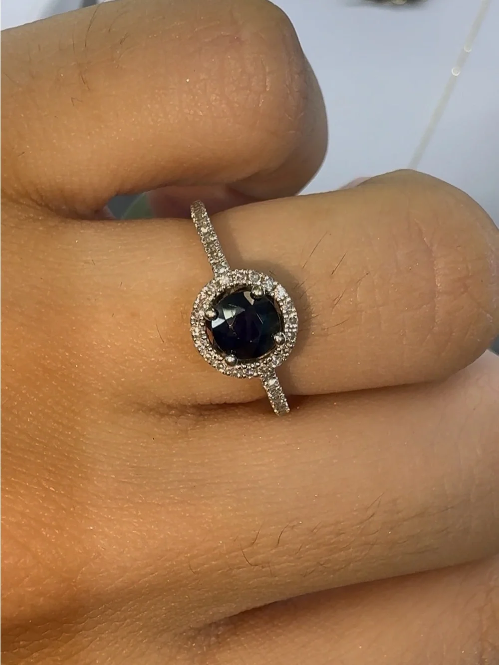 14KT white gold black diamond ring with a Pavé Halo